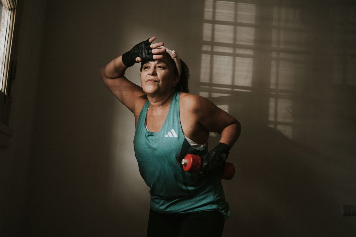 Woman exercising with a dumbbell at home