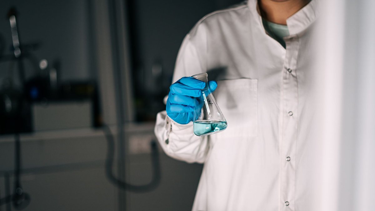 Person in a laboratory holding a flask