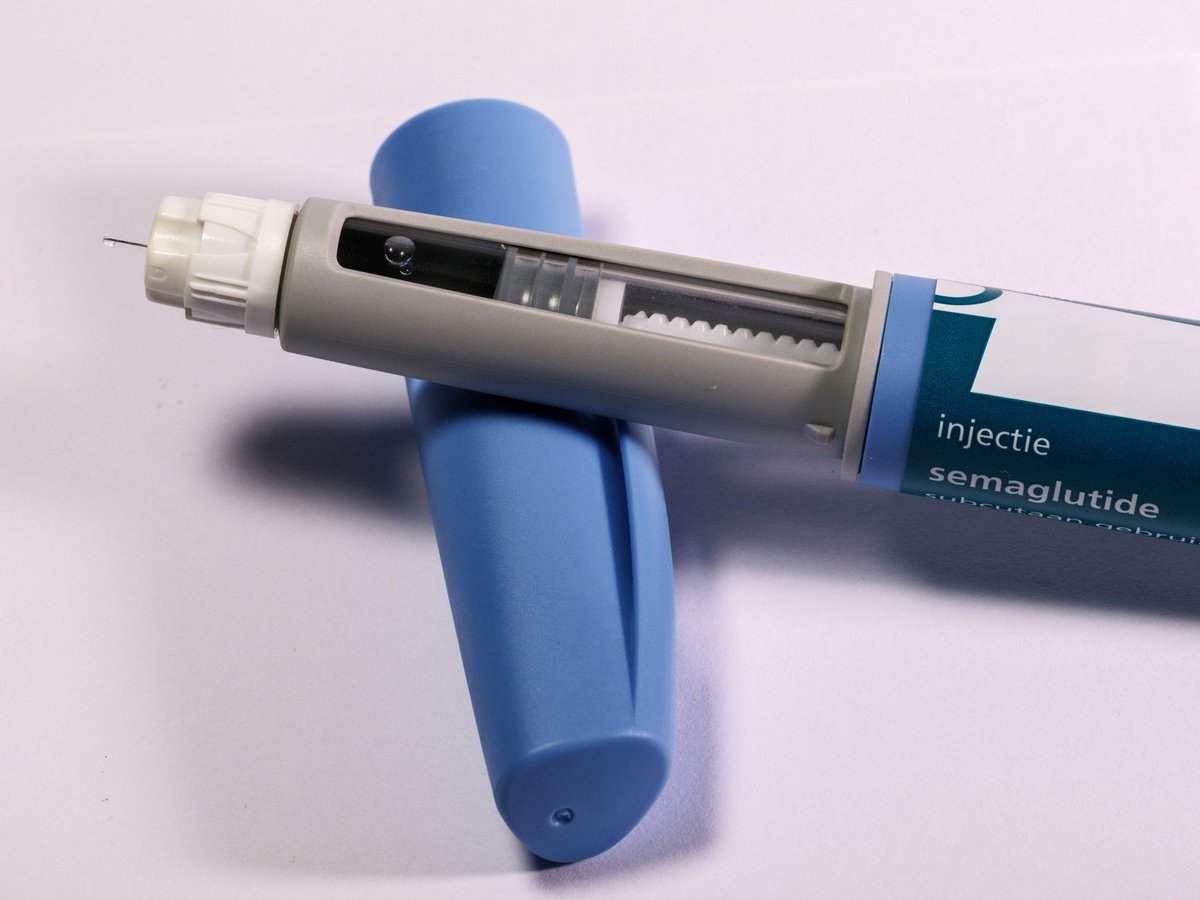 Hand holding a GLP-1 weight loss injection pen