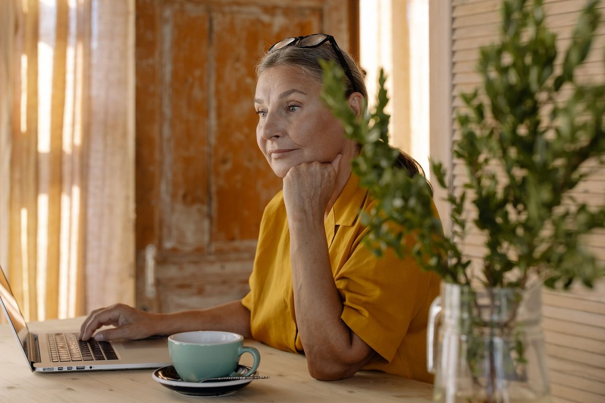 Person reading on a laptop at a table